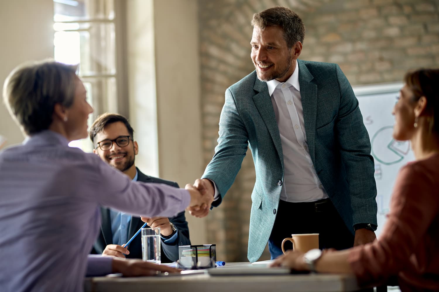 Two business partners shaking hands over a deal